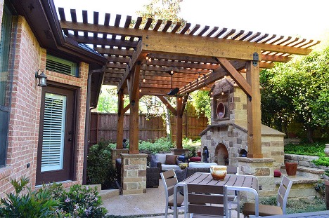 custom patio, custom pergola and outdoor fireplace combination